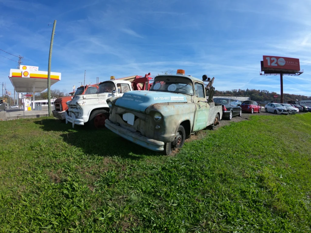 Decorative Image - Classic tow trucks in front of a gas station